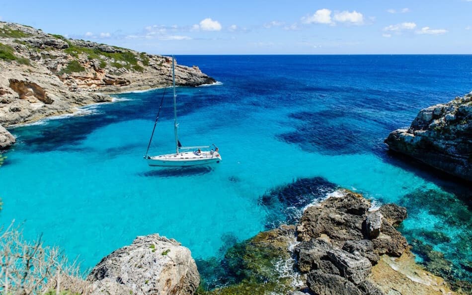 Yacht party with guests relaxing on deck under the Balearic sun