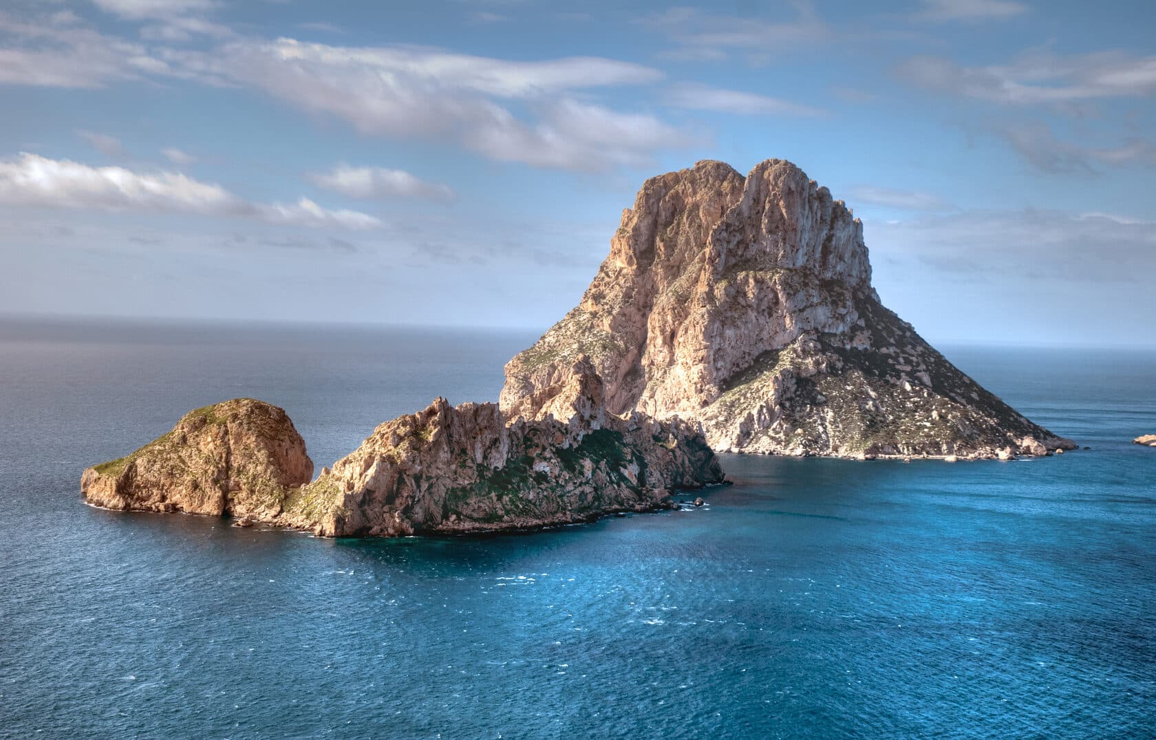 Iconic Es Vedra rock formation rising from the sea off Ibiza's coast