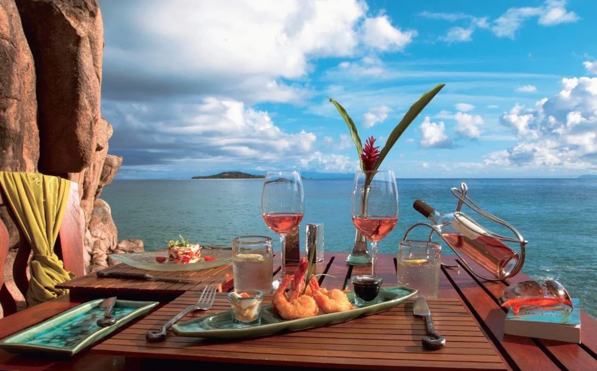 Crystal-clear water and granite boulders on a Seychelles beach